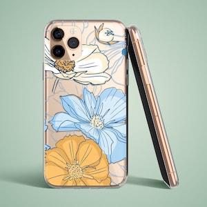 Könnte beinhalten: Eine transparente Handyhülle mit Blumenmuster. Die Hülle zeigt blaue, gelbe und weiße Blumen auf einem hellbraunen Hintergrund. Die Hülle ist für ein iPhone mit einer Dreifachkamera konzipiert.