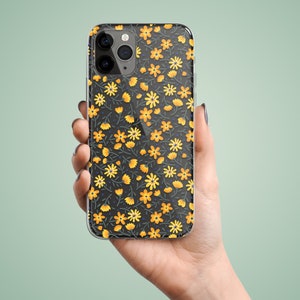 Clear phone case with illustrated yellow flowers pattern. The preview shows the case on a black iPhone device.