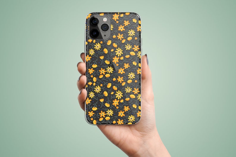 Clear phone case with illustrated yellow flowers pattern. The preview shows the case on a black iPhone device.