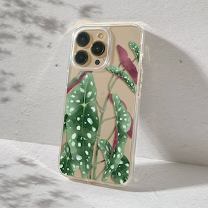 Clear phone case with an illustrated begonia polka dot. The begonia leaves are green on top and burgundy on the bottom.  The preview shows the case on a gold iPhone device.