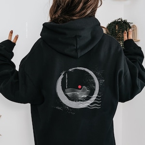 May include: Black hooded sweatshirt with a white graphic of a stylized mountain scene with a red sun on the back.
