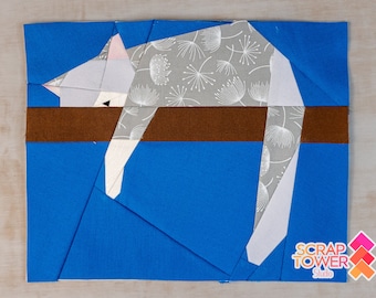 May include: A gray and white cat fabric block with a brown fabric strip, set against a blue background. The fabric block is part of a larger quilt project. The text "SCRAP TOWER Studio" is visible in the lower right corner of the image.
