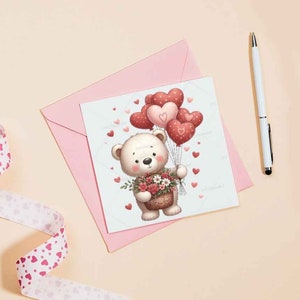 May include: A white teddy bear holding a basket of pink flowers and flying with red heart-shaped balloons. The card has a pink background and is decorated with small pink hearts.