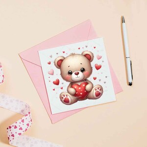 May include: A pink card with a cute cartoon teddy bear holding a red heart. The card is decorated with small pink hearts.