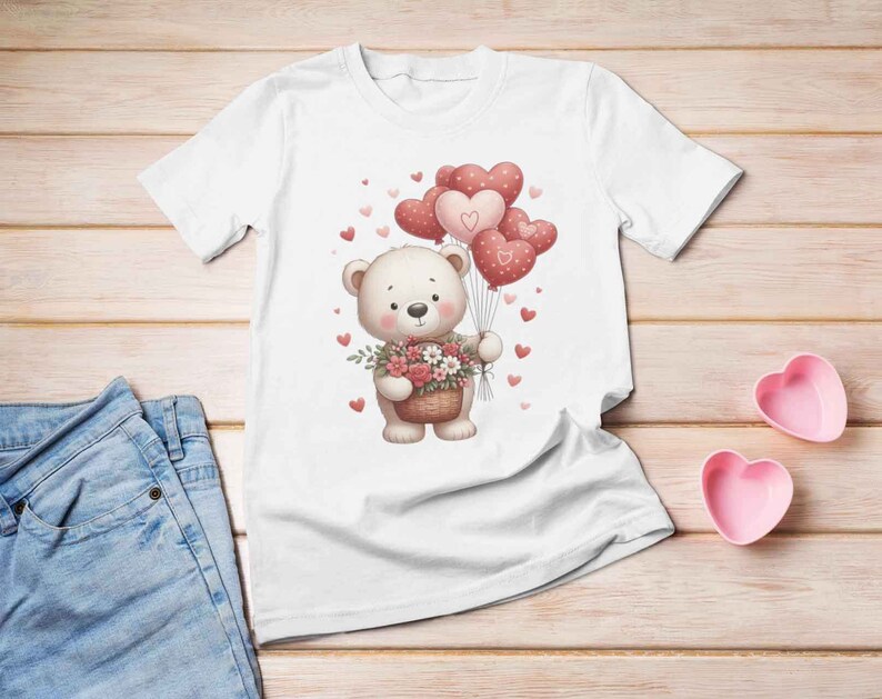 May include: White t-shirt with a cute cartoon bear holding a basket of flowers. The bear is surrounded by pink heart-shaped balloons.