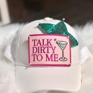 May include: White trucker hat with a pink patch that says "Talk Dirty To Me" and a green sequin star.