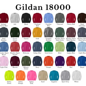 May include: A colour chart of Gildan 18000 sweatshirts, showing 36 different colours. The colours are arranged in rows and columns, with the name of each colour printed below the corresponding sweatshirt.