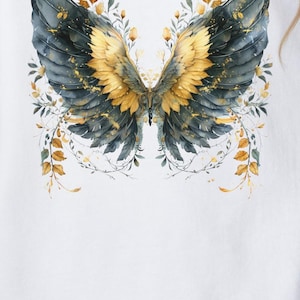 May include: A white sweatshirt with a gold and blue butterfly design on the back. The butterfly has floral accents and is surrounded by leaves. The sweatshirt is shown on a model wearing it. The text "Whimsical Sweatshirts for Women Boho Shirts Cozy Sweatshirts" is displayed below the image.
