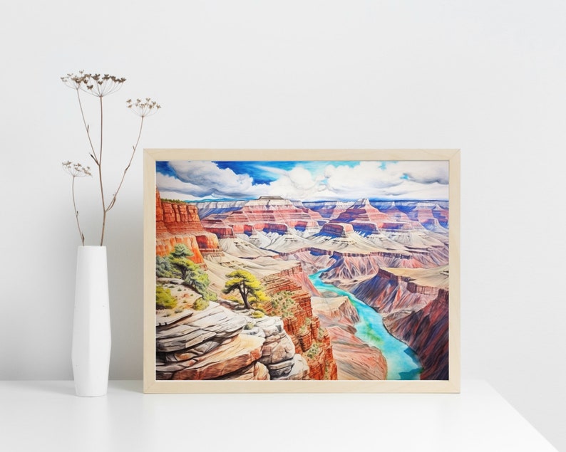 Op de afbeelding: Een ingelijst aquarel schilderij van de Grand Canyon, met een kronkelende rivier en gelaagde rotsformaties in tinten rood, oranje en bruin. De lucht is helderblauw met pluizige witte wolken.