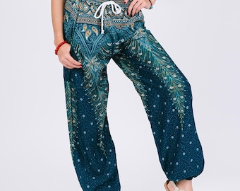 May include: Teal harem pants with a white drawstring and a detailed peacock feather design. The pants have a relaxed fit and are paired with a black sports bra. The pants are a comfortable and stylish choice for yoga or casual wear.