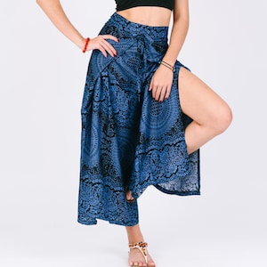 May include: Blue and black patterned pants with a side slit. The pants have a wide leg and a high waist.