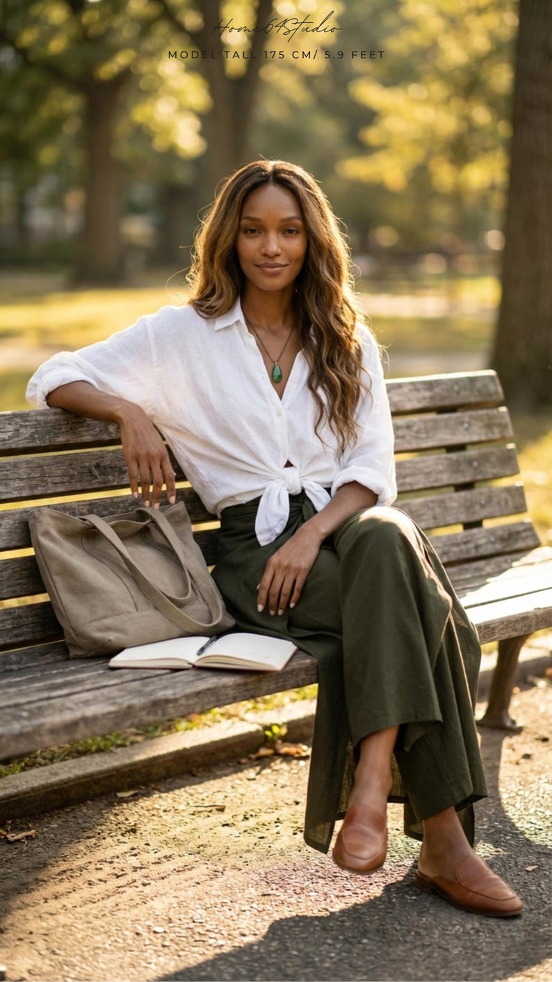 Enjoy casual everyday comfort with our Plain Army Green Palazzo Pants. 📖 Perfect for a relaxing holiday afternoon, these breathable boho fit wide-leg trousers feature a stylish side slit and a waist-defining front tie. Seen styled elegantly on a park bench with a classic tied white linen shirt and slip-on loafers. These versatile olive green wrap pants transition effortlessly from a morning coffee run to a tranquil afternoon reading session. Your new go-to sustainable summer wardrobe staple! ☕