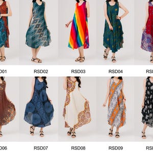 Woman poses in boho maxi sleeveless dress, made for summer vibes and festival wear. Soft, colorful, and unique.
