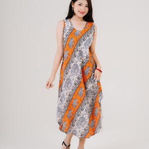 A-line sleeveless maxi dress worn by woman in sandals. Summer outfit with breathable fabric for festivals or daily use.