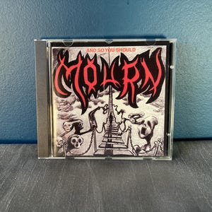 Puede incluir: Caja de CD con el álbum "And So You Should" de Molrn. La portada es una ilustración en blanco y negro con letras rojas. La obra de arte representa una escena surrealista con figuras y una escalera.