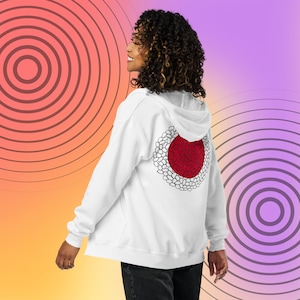 May include: White hooded sweatshirt with a red and white circle design on the back. The design resembles a stylized Japanese flag.