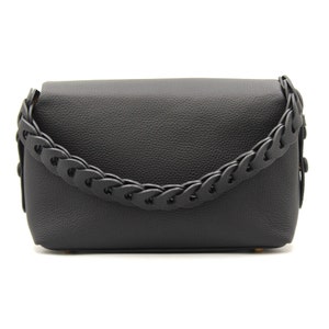 May include: Black leather shoulder bag with a braided strap.