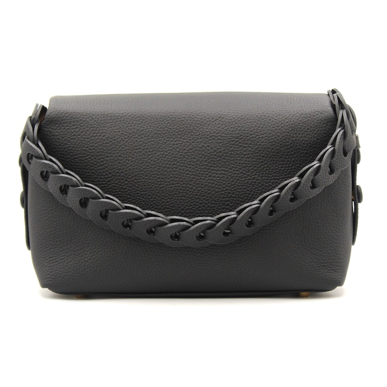 May include: Black leather shoulder bag with a braided strap.