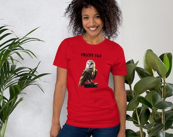 May include: Red short-sleeved t-shirt with a white barn owl graphic and the text "Knight Owl" printed in black.
