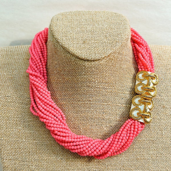 1973 Mimi Di N hot pink, multi strand, beaded collar style necklace with gold class bow stamped with a rope design. Approximately 17 inches