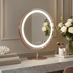 May include: A rose gold, circular vanity mirror with an illuminated LED ring. The mirror features a touch control panel and is mounted on a stand. White roses and makeup brushes are on the marble surface.