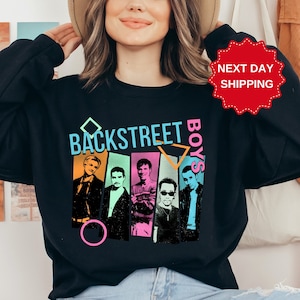 May include: Black sweatshirt with a graphic print of the Backstreet Boys in colorful geometric shapes. The text "Backstreet Boys" is printed in white.