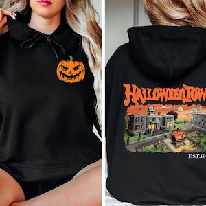 May include: Black hoodie with a pumpkin graphic on the front and "HALLOWEEN TOWN EST. 1998" text on the back. The pumpkin graphic has a spooky face and the text is in a vintage style font.