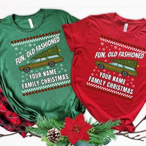 May include: Green and red t-shirts with a Christmas theme. Each shirt features a station wagon carrying a Christmas tree, with the text "FUN, OLD FASHIONED, YOUR NAME, FAMILY CHRISTMAS". Festive holiday apparel.