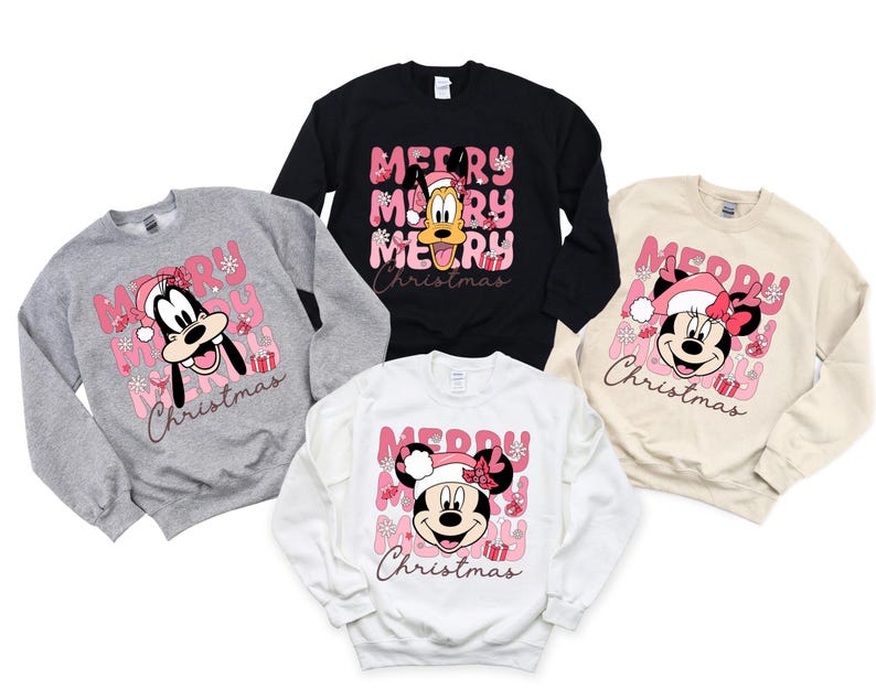 May include: Four sweatshirts with a pink and white Christmas theme. The sweatshirts feature Mickey Mouse, Minnie Mouse, and Goofy. The text on the sweatshirts reads "Merry Christmas".