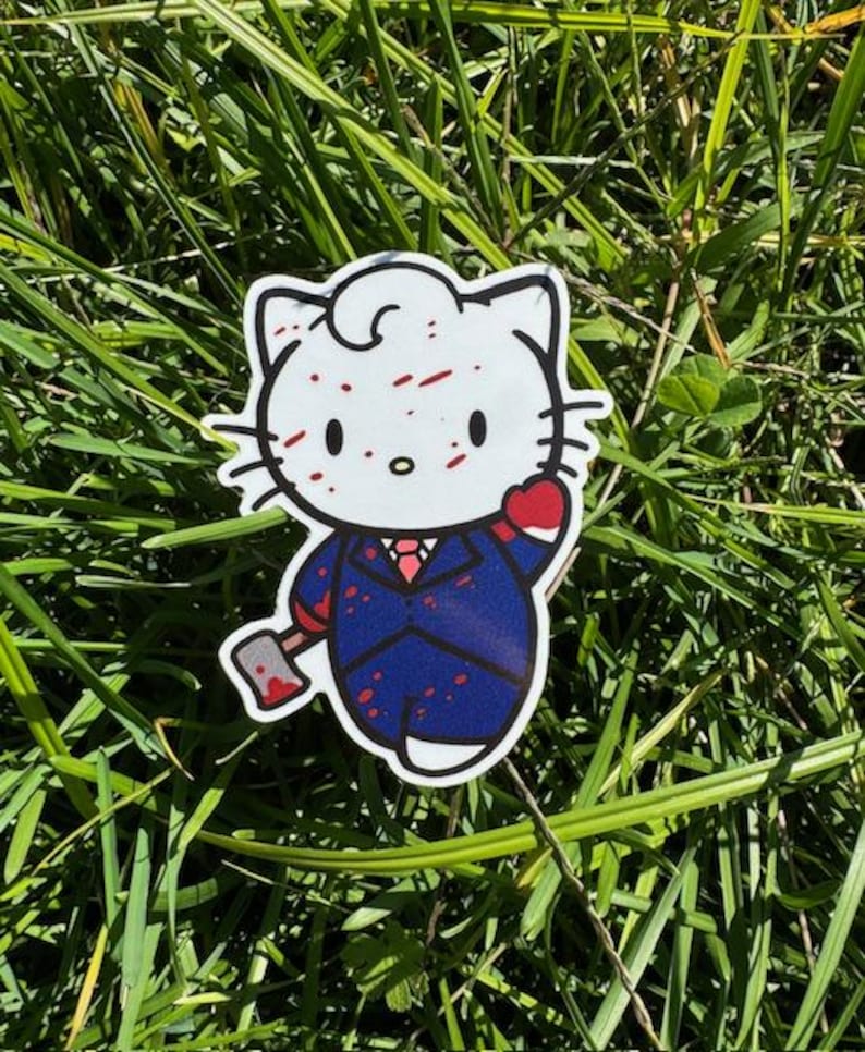 Puede incluir: Un gato de dibujos animados blanco con salpicaduras de pintura roja en la cara, que lleva un traje azul y sostiene un hacha. El gato tiene un coraz&oacute;n rojo en el pecho y una corbata roja.