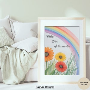 Könnte beinhalten: Ein Aquarellbild eines Regenbogens mit drei Sonnenblumen und dem Text "Feliz Dia de la madre" auf Spanisch. Das Bild ist in einem hellen Holzrahmen gerahmt.