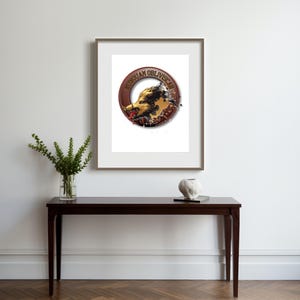 May include: A framed print with a circular emblem, the text "XONGUAN OBLIVISCAR" encircling an image of an animal head. The print is displayed on a dark wood table, alongside a vase of greenery and a decorative sculpture.