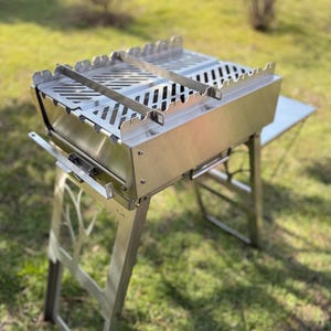 Portable grill with side table and grill grate. Barbeque-suitcase! Stainless steel barbeque! BBQ!