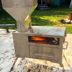 Powerful stove for outdoor camping or small spaces! Gravity feed pellet stove with oven and cook top!
