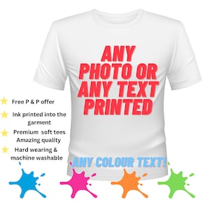 May include: White t-shirt with the text "ANY PHOTO OR ANY TEXT PRINTED" in red. The text "ANY COLOUR TEXT!" is also visible in blue. Four paint splatters in blue, pink, orange, and green are at the bottom of the image.