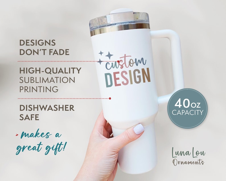 May include: A white 40oz capacity tumbler with a handle, featuring the text "custom DESIGN" in colorful letters. The design promises to not fade and is dishwasher safe. The image also includes the text "makes a great gift!"