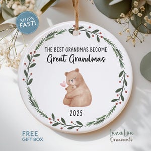 May include: A white ceramic ornament with a brown string for hanging. The ornament features the text "THE BEST GRANDMAS BECOME Great Grandmas" and a watercolor illustration of two bears. The year "2025" is printed below the bears.
