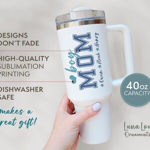 May include: White 40 ounce stainless steel travel mug with a blue and white design that says "boy MOM" and "Owen Noah Henry".