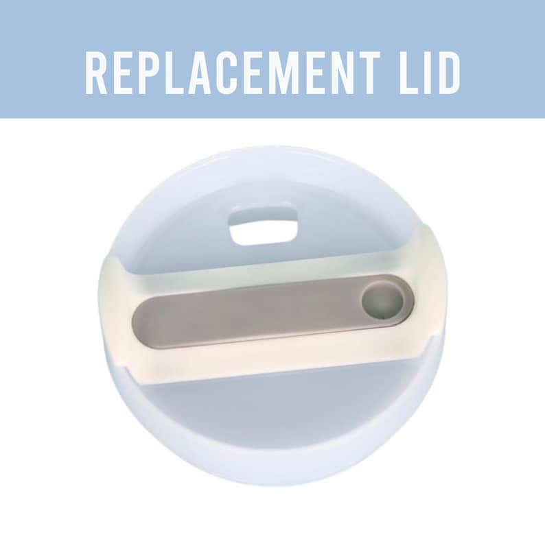 May include: A light blue replacement lid with a white and gray handle. The lid has a small, rectangular opening and a circular indentation. The text "REPLACEMENT LID" is displayed in white.