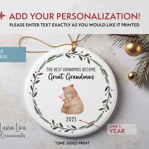 May include: A white ceramic ornament with a gold string for hanging. The ornament features a watercolor illustration of a bear holding a smaller bear, surrounded by a green wreath. Text reads "THE BEST GRANDMAS BECOME Great Grandmas" and "2025".