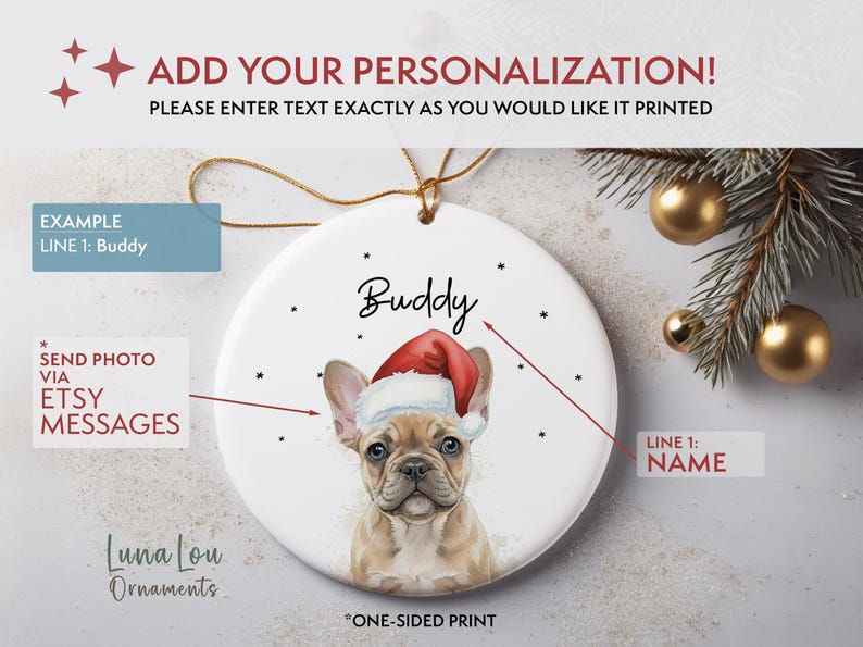 May include: A round white ceramic ornament featuring a tan French Bulldog wearing a red and white Santa hat. The name Buddy is printed in black script above the dog. The ornament includes a gold hanging string and a one-sided print design.