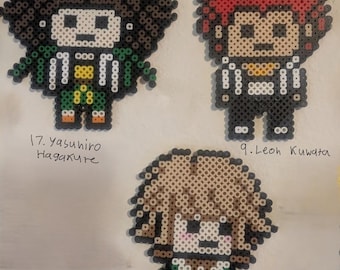 May include: Three pixel art figures of anime characters. The figures are made of small, colorful beads. The first figure is Yasuhiro Hagakure, the second is Leon Kuwata, and the third is Chihiro Fujisaki. Each figure has a unique design and color scheme.