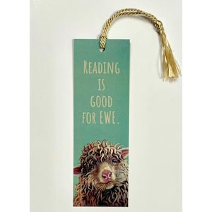 May include: A teal bookmark with the text "READING IS GOOD FOR EWE." features a sheep illustration at the bottom. The bookmark has a gold tassel and cord for easy placement in a book. A fun gift for book lovers.
