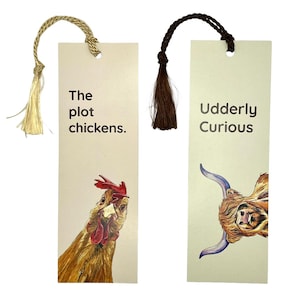 May include: Two rectangular bookmarks with decorative tassels. One bookmark features a watercolor illustration of a chicken with the text "The plot chickens." The other bookmark has a watercolor illustration of a cow with the text "Udderly Curious."