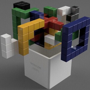 May include: A 3D puzzle with colorful blocks in a white box. The box has the text "Troublesome Puzzles" printed on the side. The puzzle is made of different colored blocks, including red, blue, green, yellow, and white.