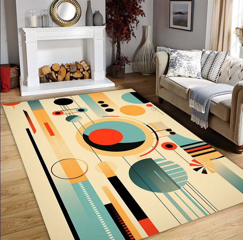 May include: A rectangular area rug featuring a cream-colored background with a geometric pattern of circles, lines, and rectangles in shades of teal, orange, and black. The design includes various circular shapes, thin black lines, and solid blocks.