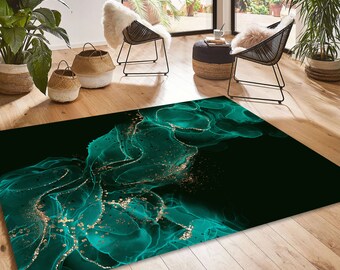 May include: A rectangular area rug featuring an abstract fluid art design with deep emerald green and black tones. The pattern includes swirling ink-like textures accented by scattered gold-colored flecks that create a shimmering effect across the surface.