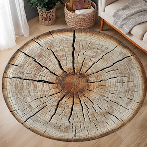 May include: A round, brown and beige area rug with a tree trunk design. The rug has a circular shape and features a realistic wood grain pattern.