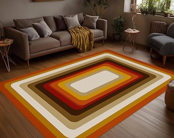 May include: A rectangular area rug featuring a series of concentric rounded rectangles in shades of orange, yellow, brown, and cream. The pattern creates a layered, tunnel-like effect across the surface, with a textured finish throughout the design.