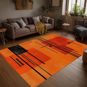 May include: A rectangular area rug featuring a vibrant orange background with a geometric pattern of black lines and solid black and dark orange rectangular shapes. The design is composed of intersecting horizontal and vertical lines.